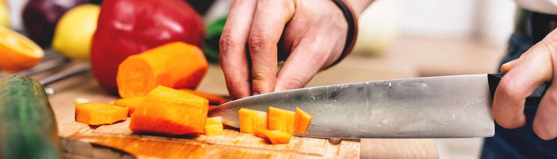 Cook Cutting Vegetables at Kitchen